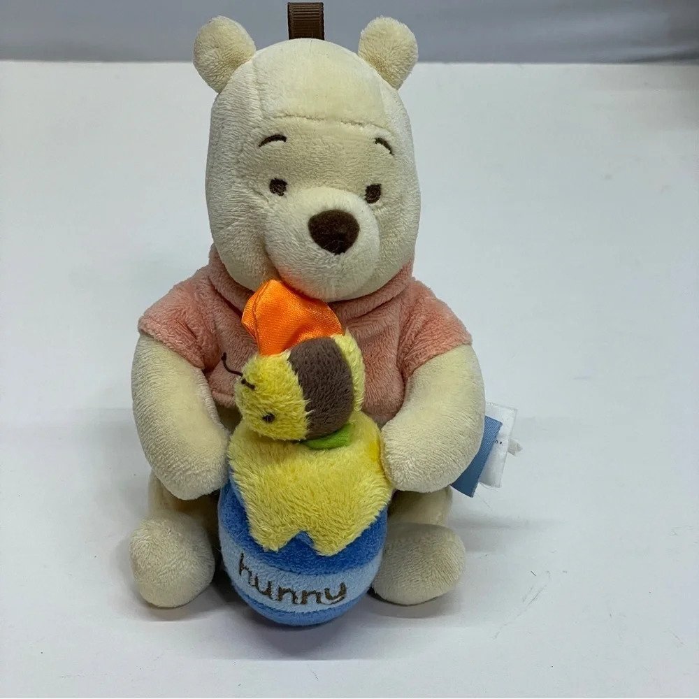 Disney baby Winnie the Pooh bear with a honeypot with bee
